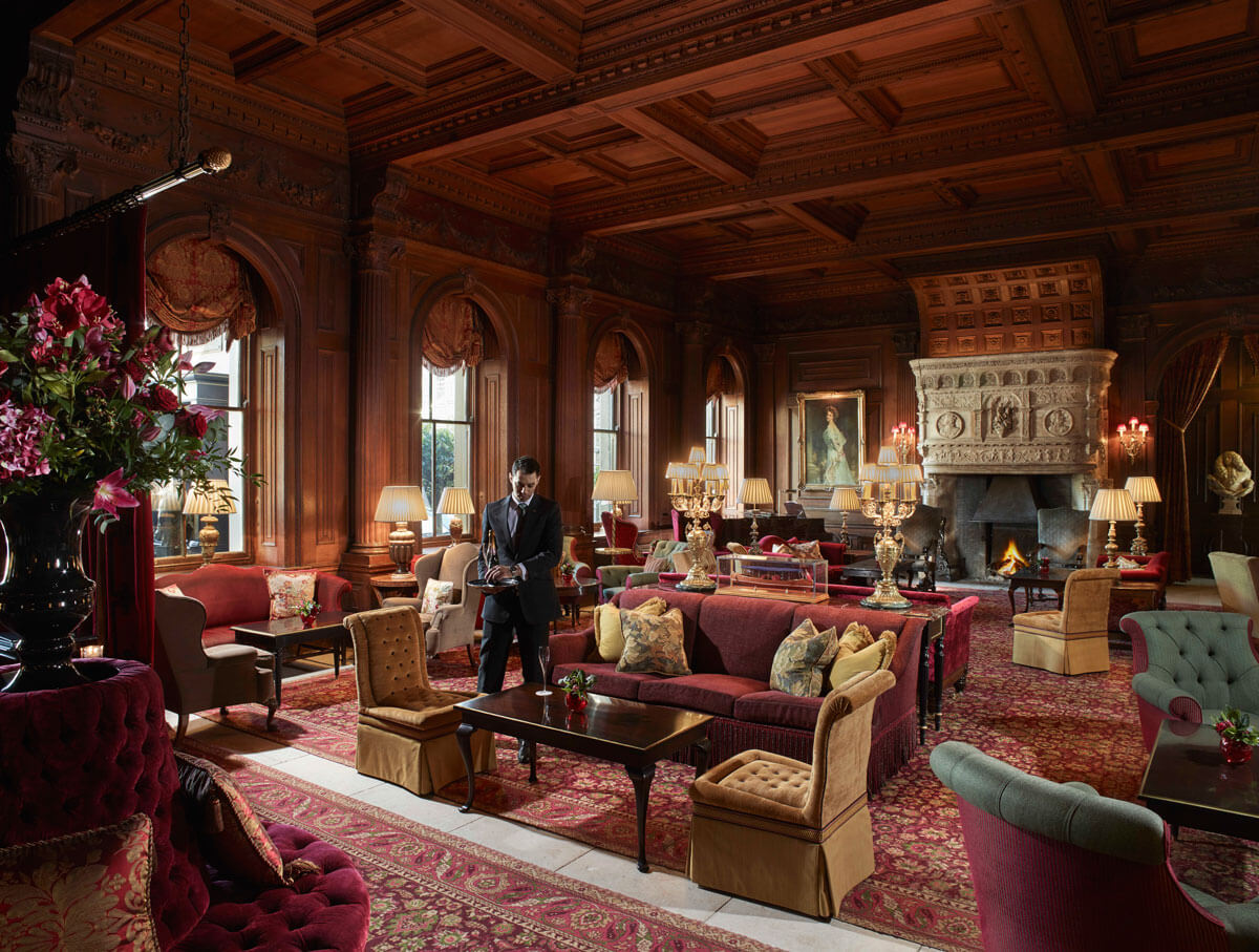 Image of grand drawing room with waiter at cliveden house stately home near london