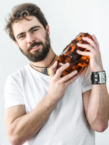 Art Director of Moser Glass holding glass object
