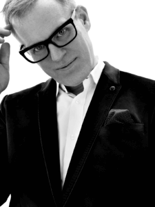 Black and white portrait of luxury eyewear designer Tom Davies