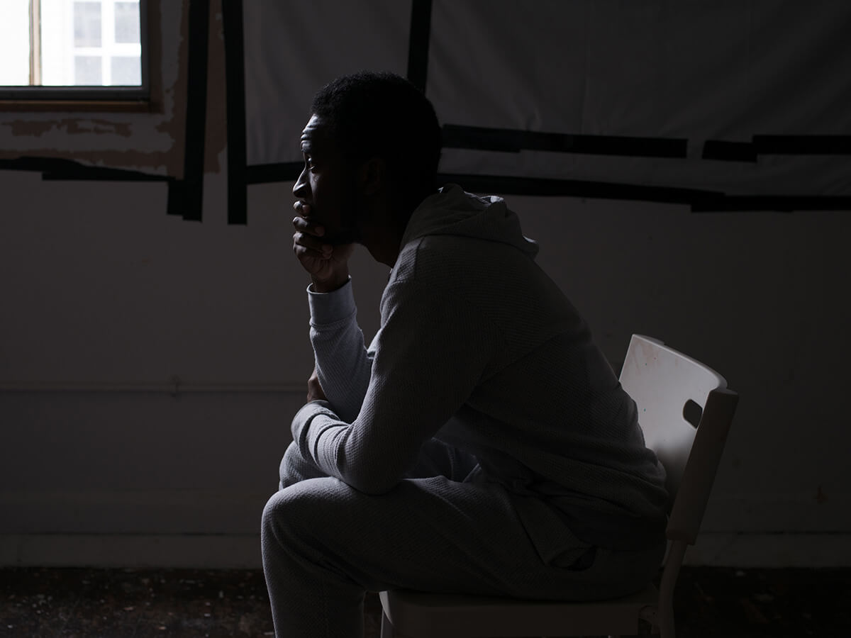 portrait of poet Kayo Chingonyi creating poetry in the dark