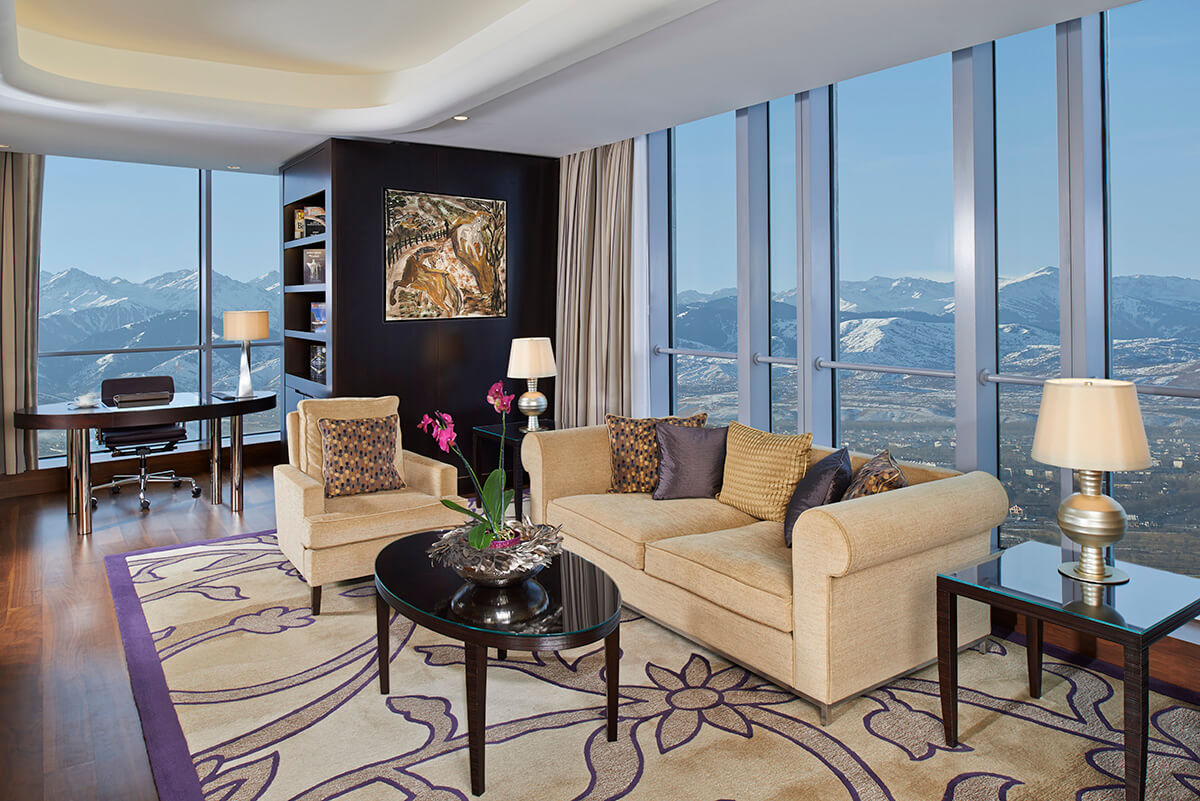 An executive suite at the Ritz Carlton Almaty with winter views of the snowy mountain range