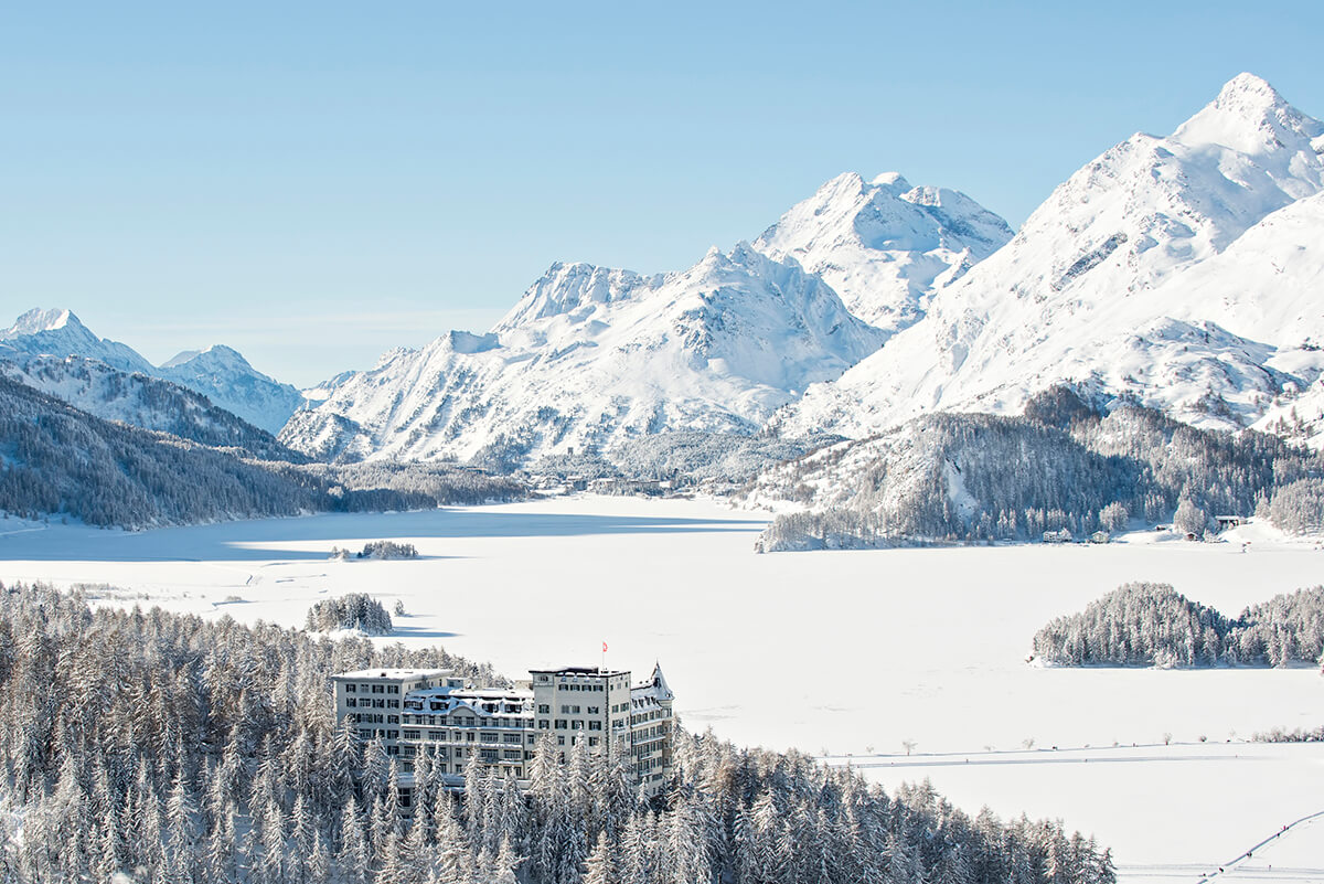 5 star swiss hotel Waldhaus Sils in winter surrounded by snowy mountains and frozen lakes