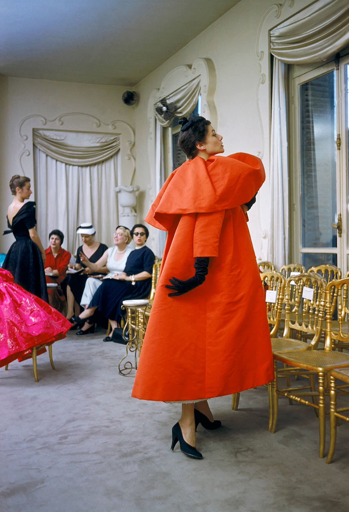 Orange Balenciaga coat on display at fashion presentation in Paris in 1954