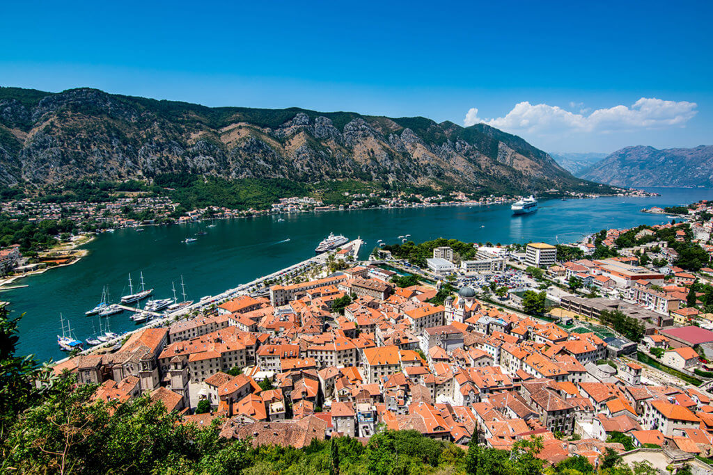 Montenegro's blue skies and mountains surrounding Boka Bay