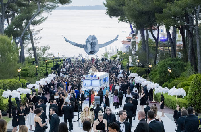 celebrity guests arriving at gala in cannes underneath sculpture