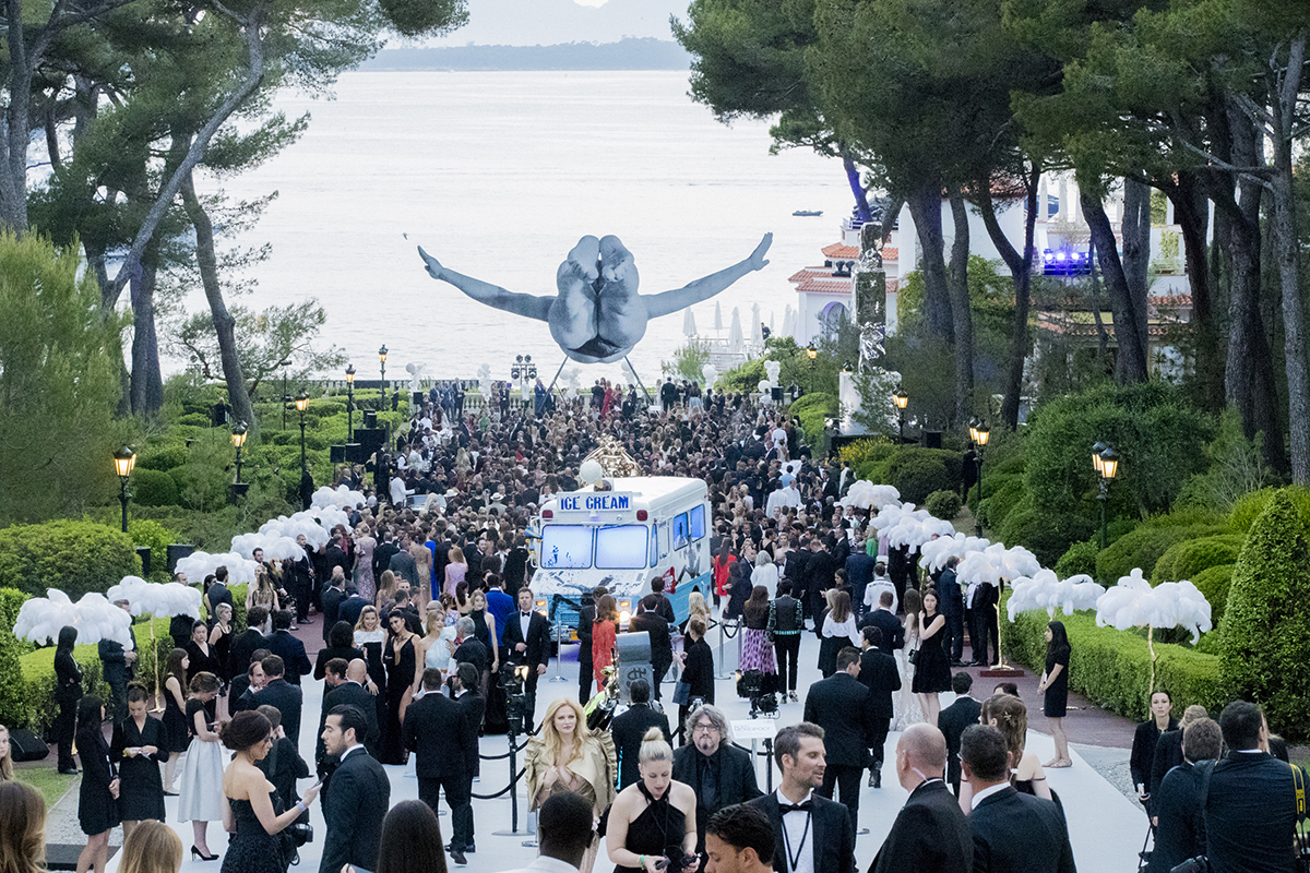 celebrity guests arriving at gala in cannes underneath sculpture 