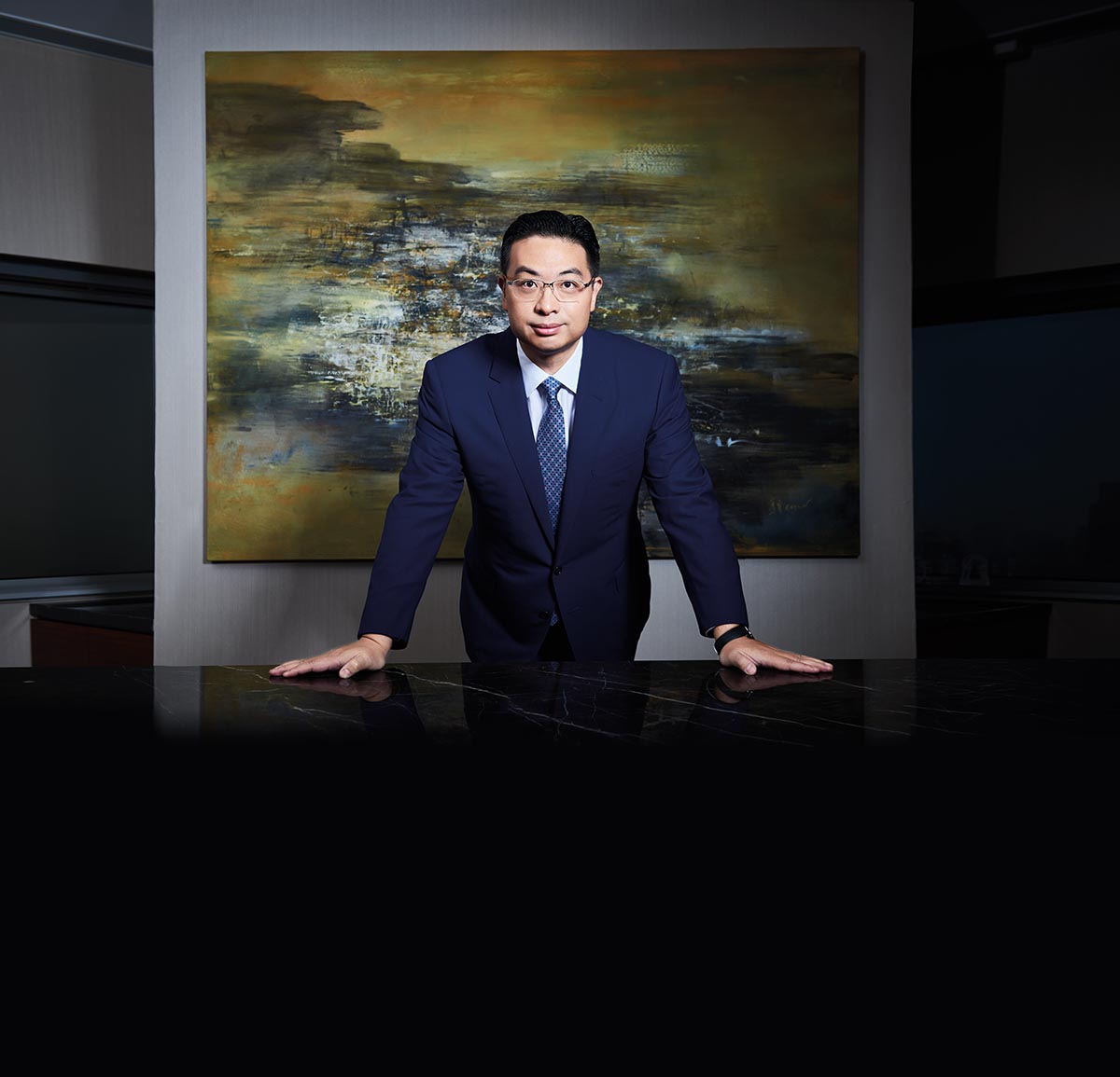 Portrait of Founder of venture capital and investment company Global Group Johnny Hon in front of artwork