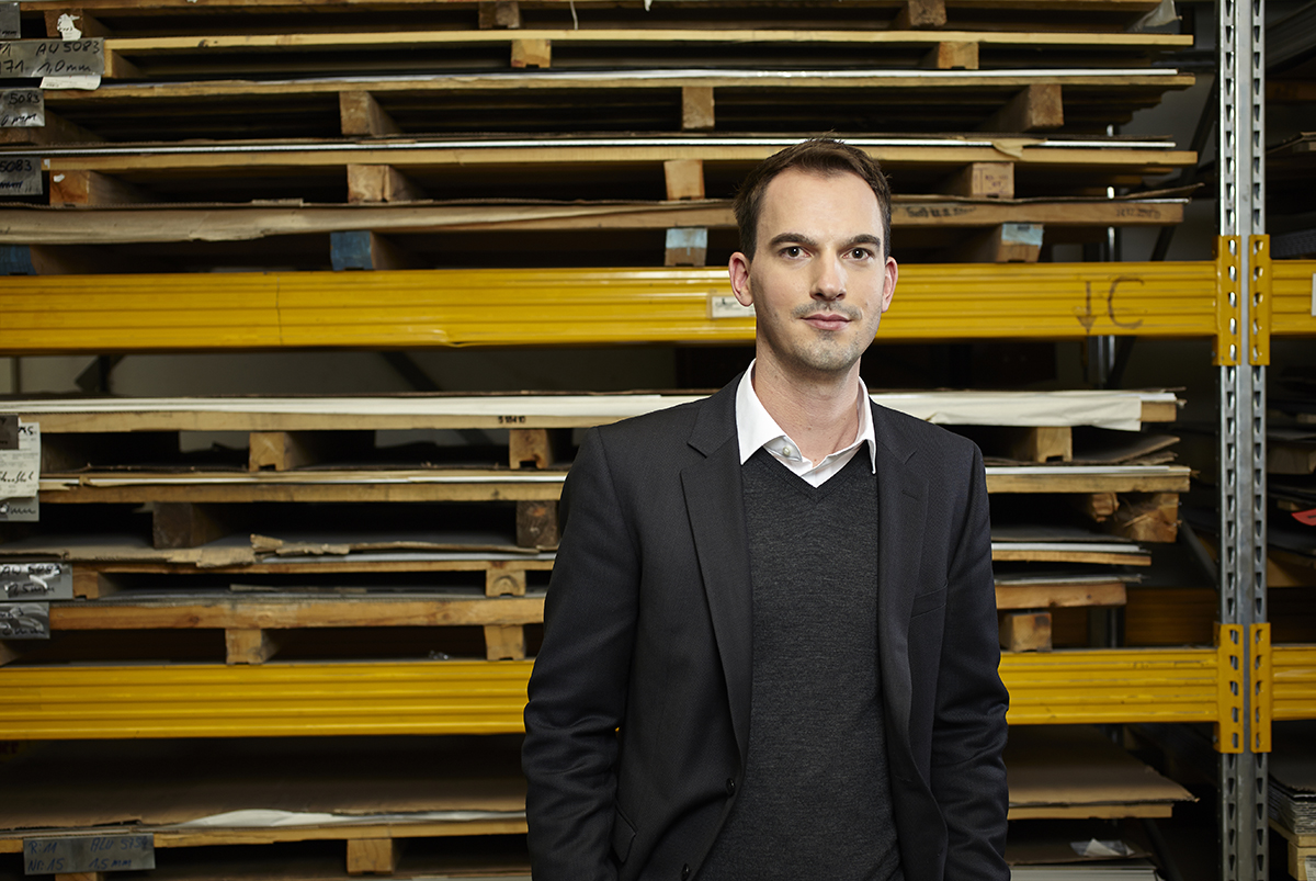 Portrait of Gaggenau designer Lars Dinter standing in front of industrial site