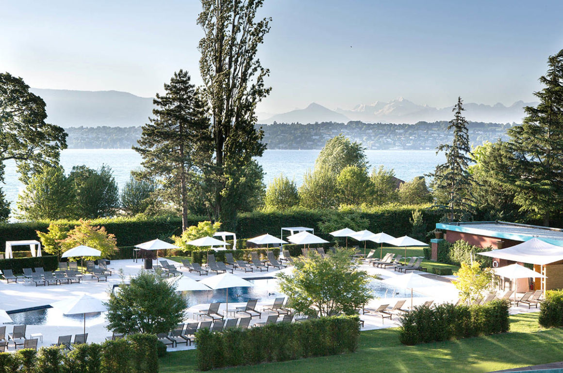 Luxury hotel pool area on the edge of Lake Geneva