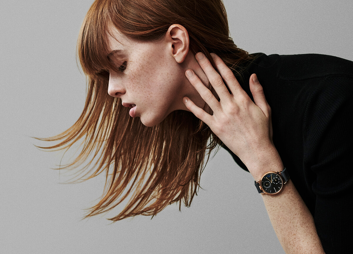 campaign image with red haired model wearing luxury watch