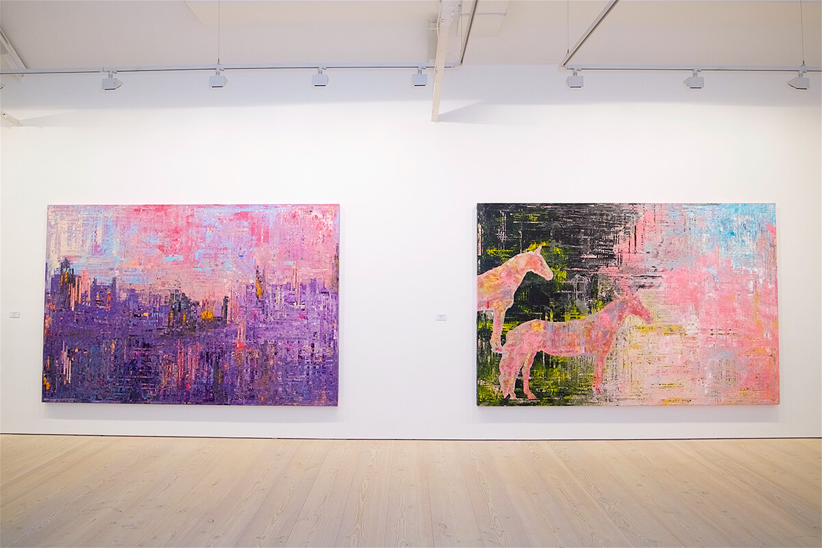 Two large scale colourful paintings by Sassan Benham-Bakhtiar hanging on gallery wall