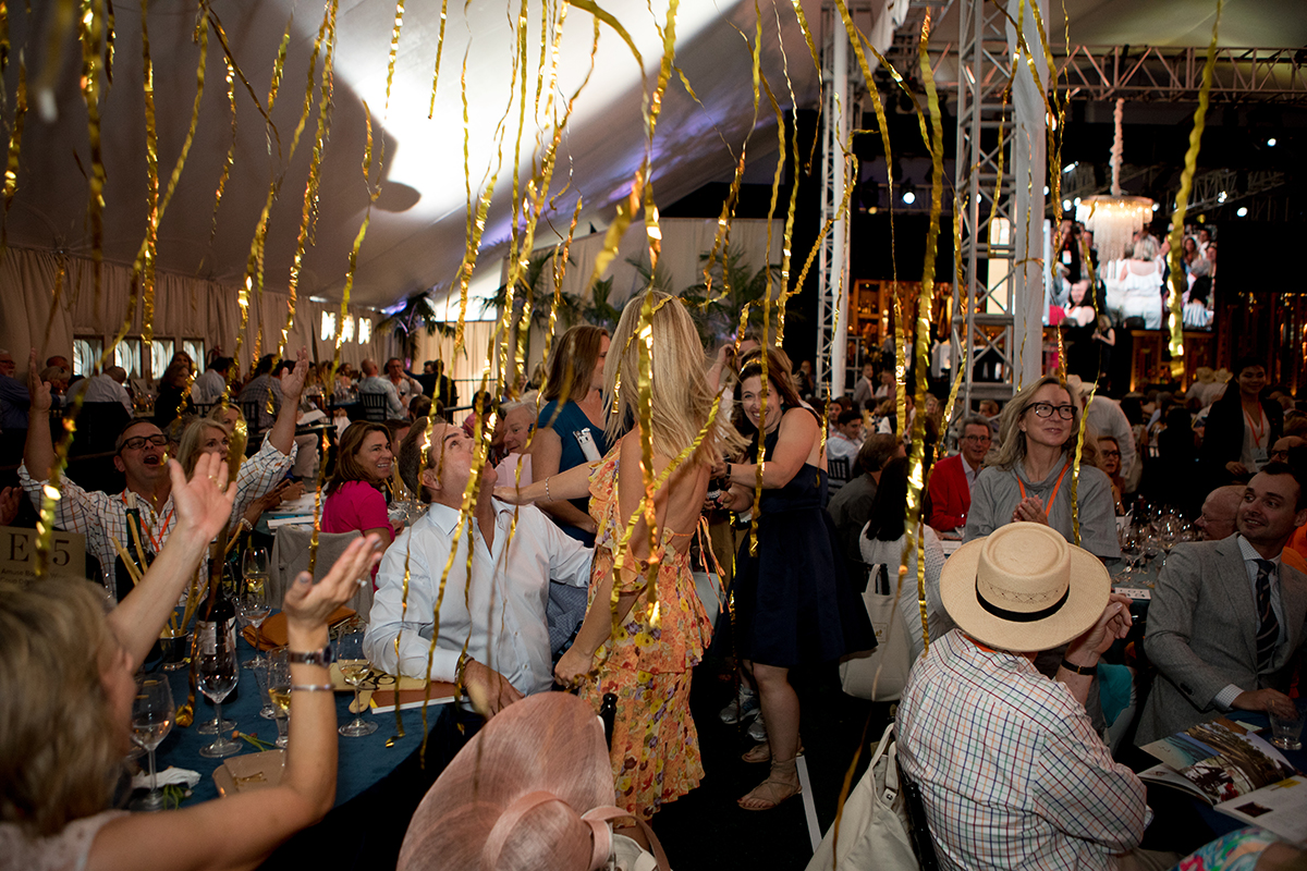 wild party with gold streamers inside a luxury marquee