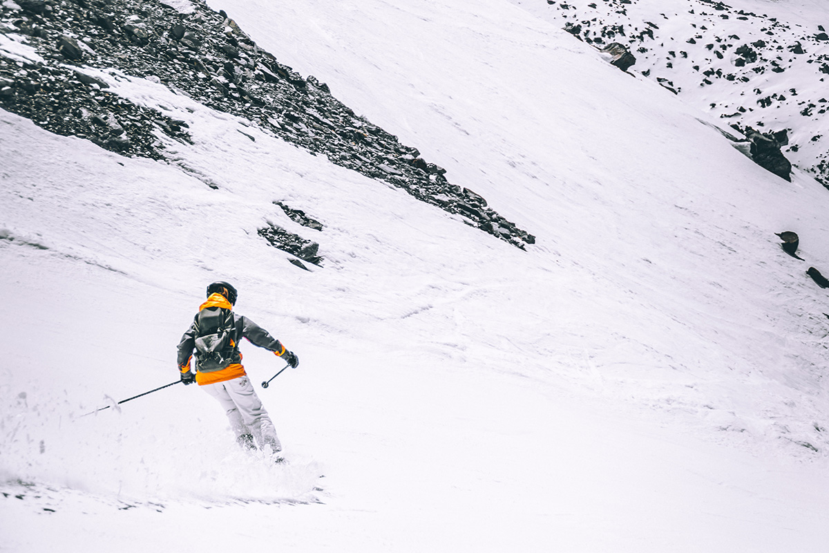 Skier in a yellow jacket on the piste