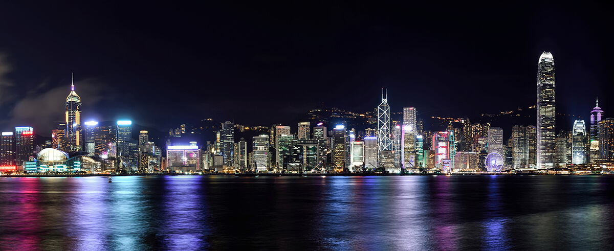 Night time image of Hong Kong with lights reflecting on water