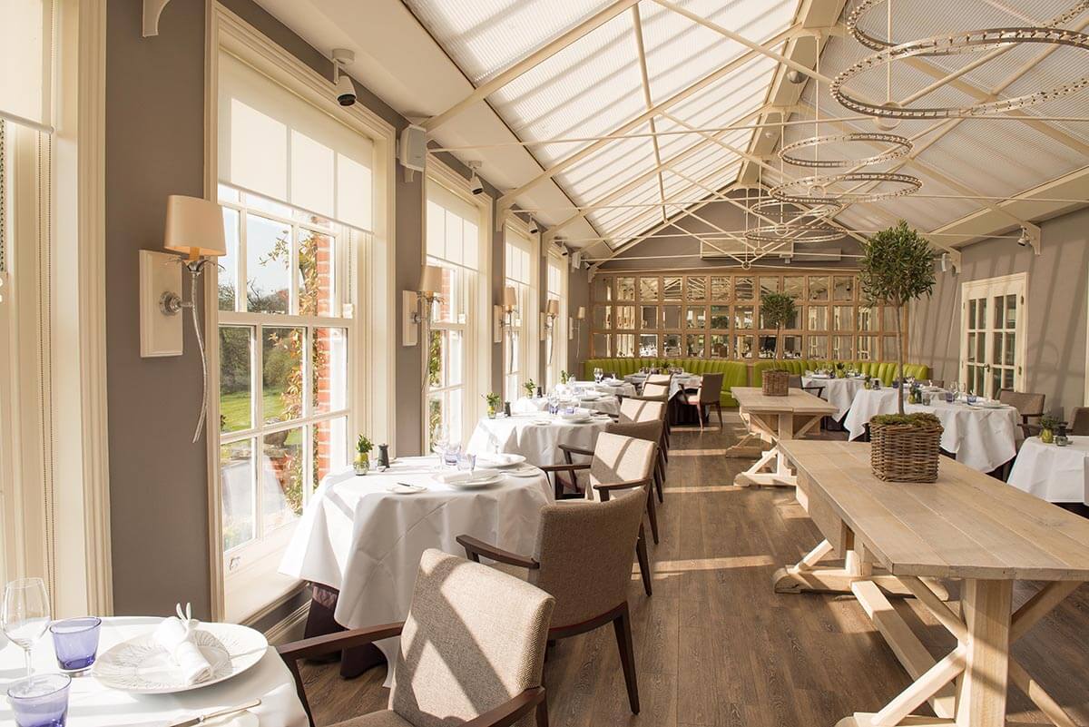 luxury restaurant with tables inside a modern conservatory