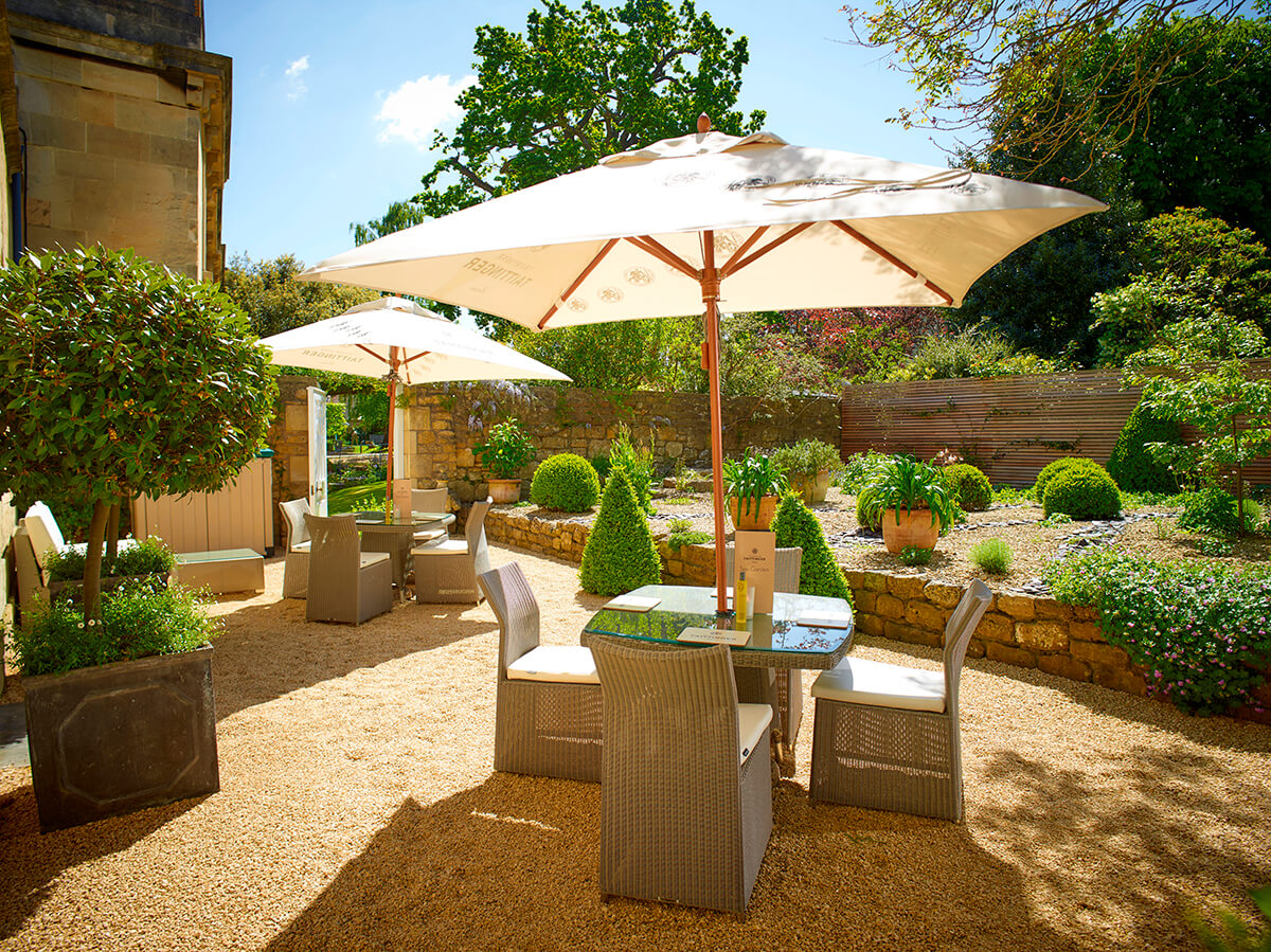 luxury outdoor seating area with tables and unmbrellas