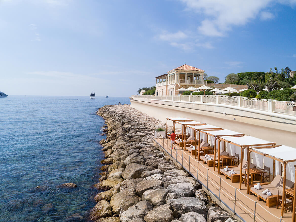 Line of luxury sunbeds along the ocean front