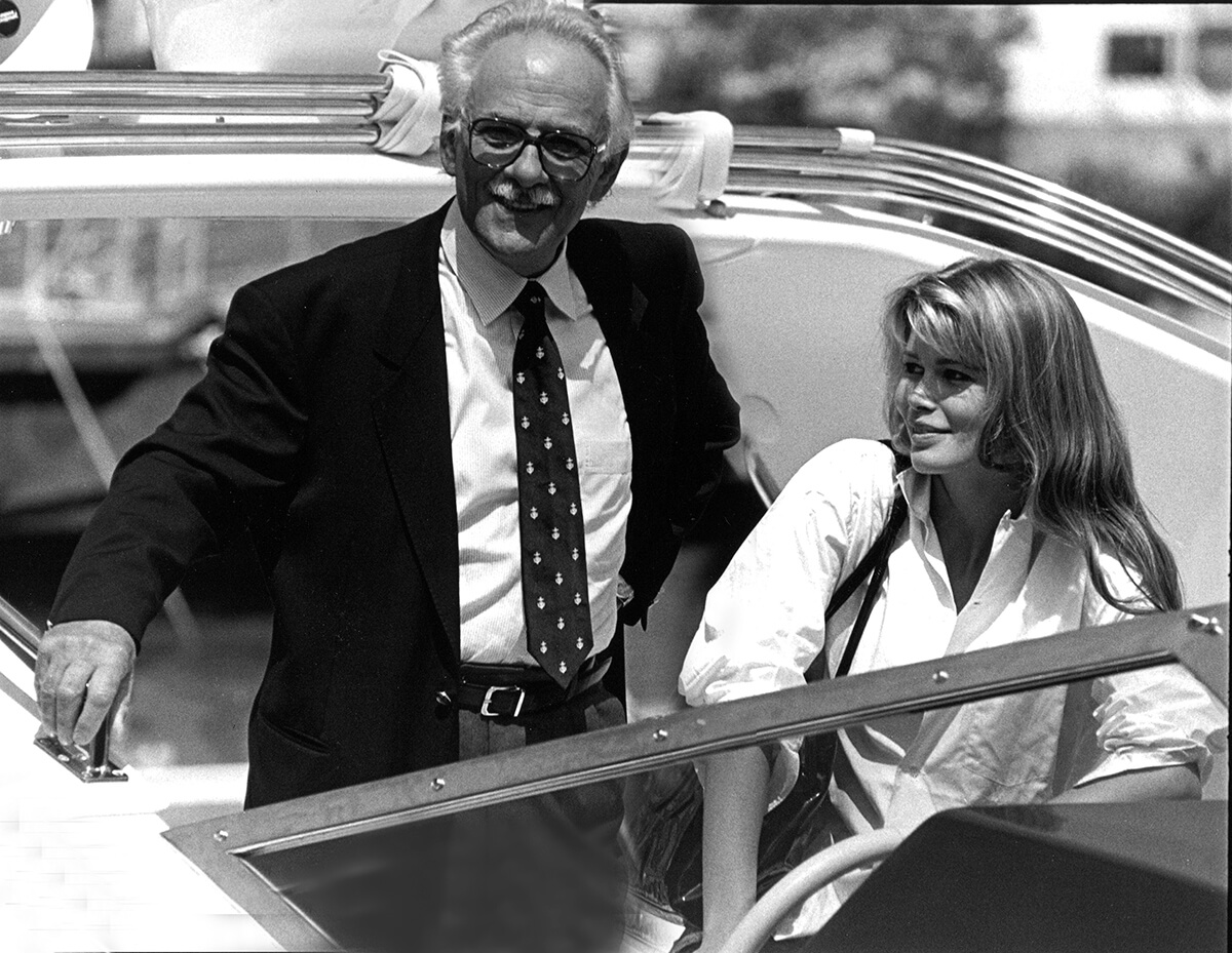 Vintage image of Carlo Riva pictured with Claudia Schiffer onboard a speed boat 