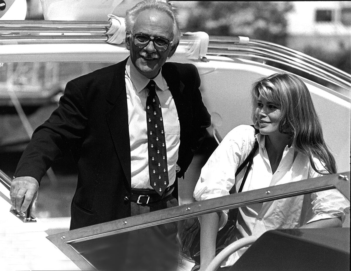 Vintage image of Carlo Riva pictured with Claudia Schiffer onboard a speed boat 