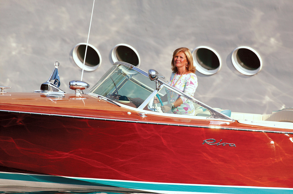 Vintage aesthetic of a Riva boat with Lia Riva on board