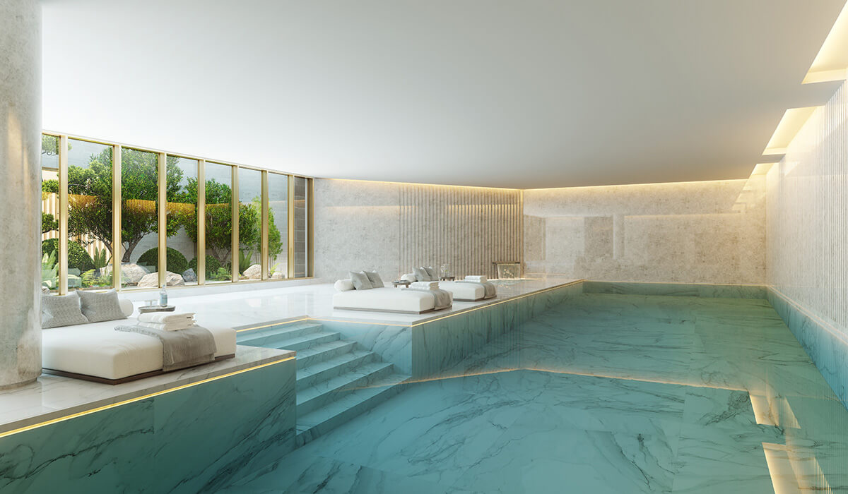 Luxury indoor swimming pool with plush sun loungers