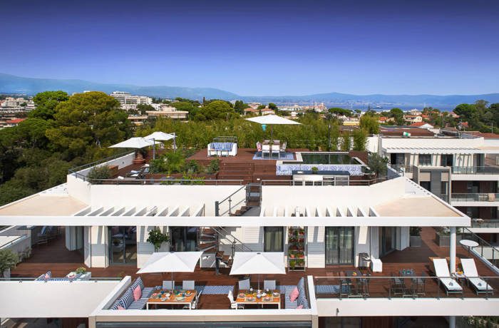 view of luxury penthouse suite with wooden decking and outdoor seating areas