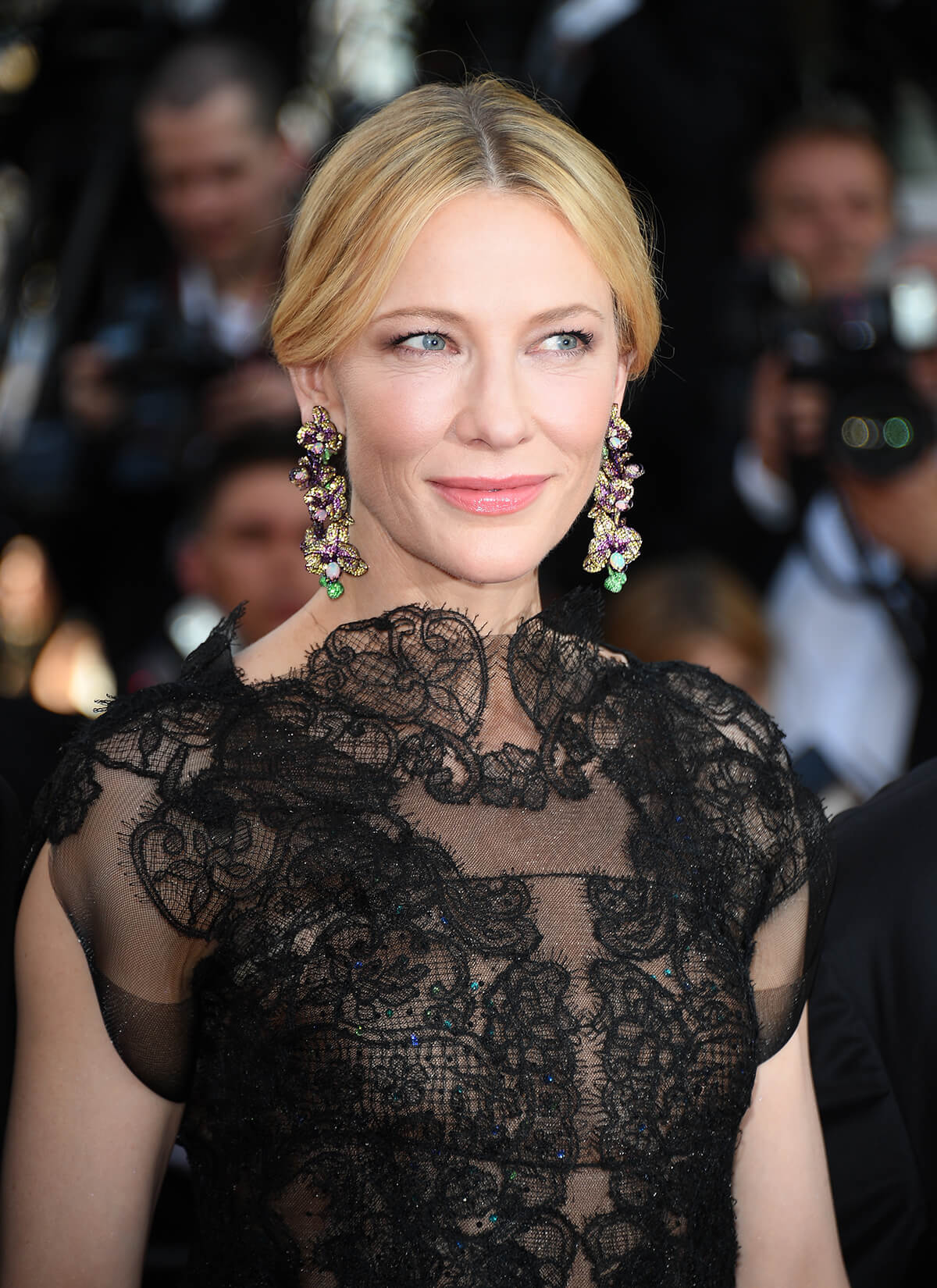 Actress Cate Blanchett on the red carpet in diamond emerald earrings and a black lace dress