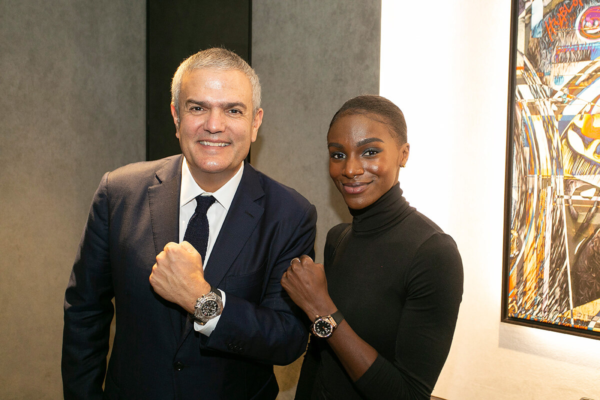 Ricardo Guadalupe and Dina Asher-Smith pose with watches on their wrists