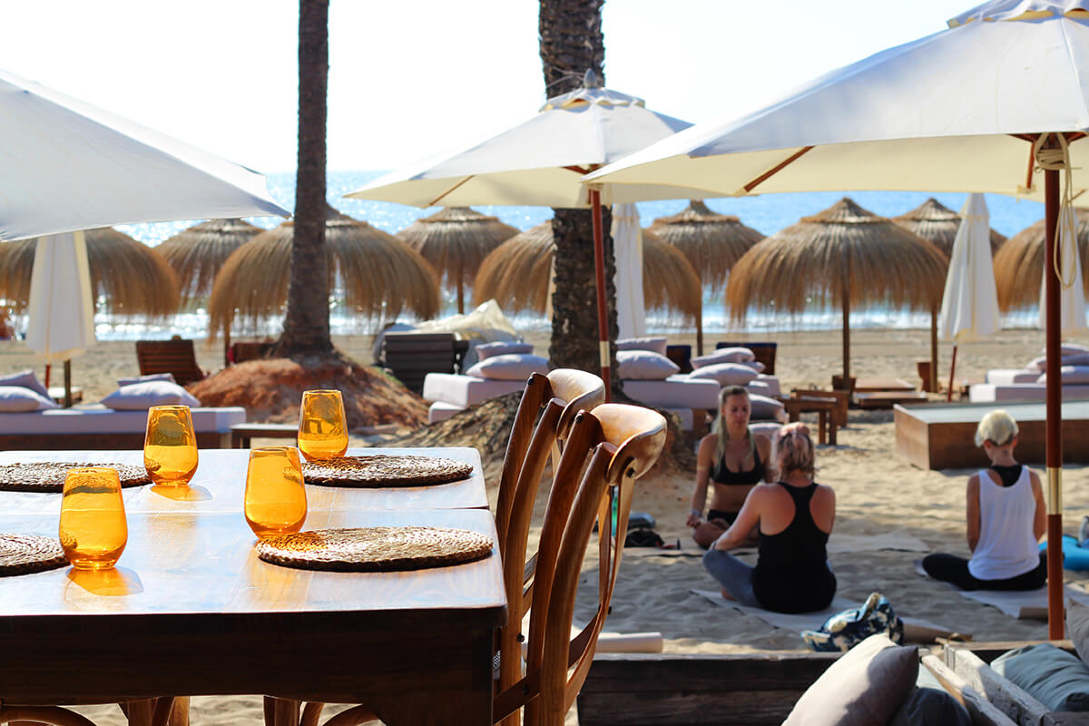 Beach yoga lesson in front of beach restaurant