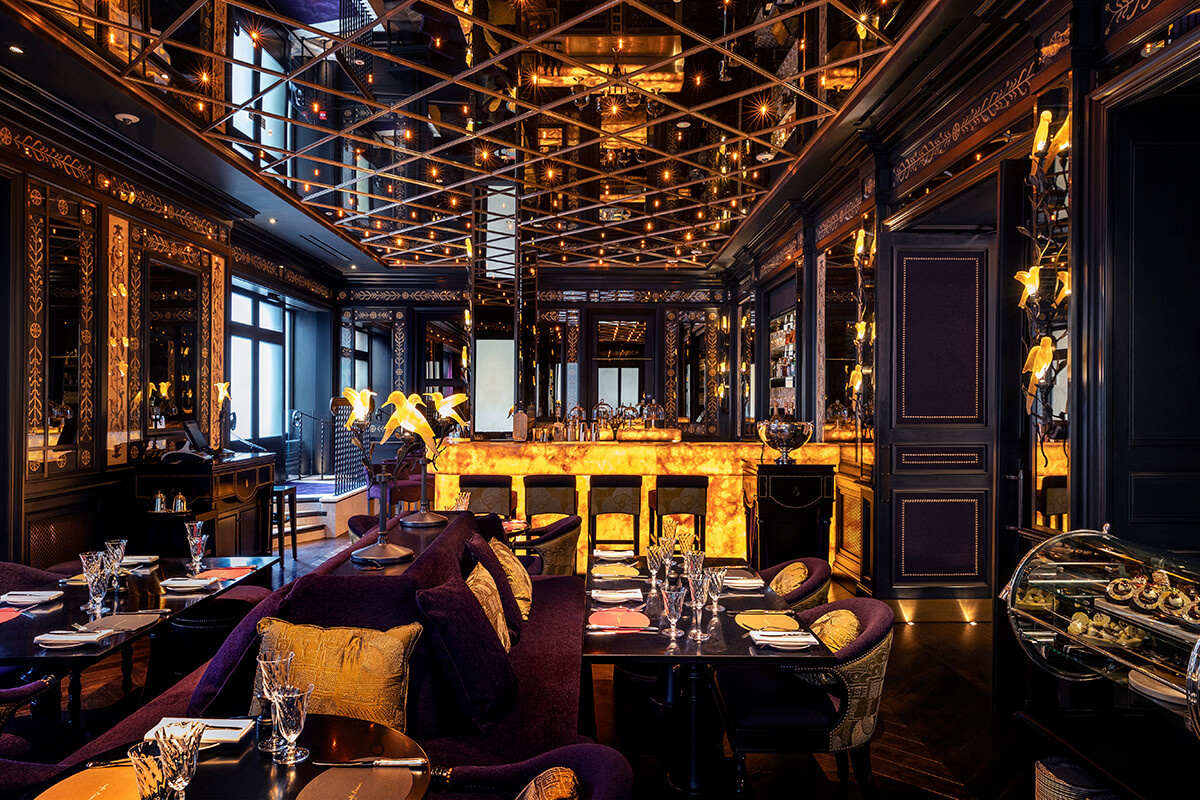 Decadent dining area with mirrored ceiling and gold and purple detailing