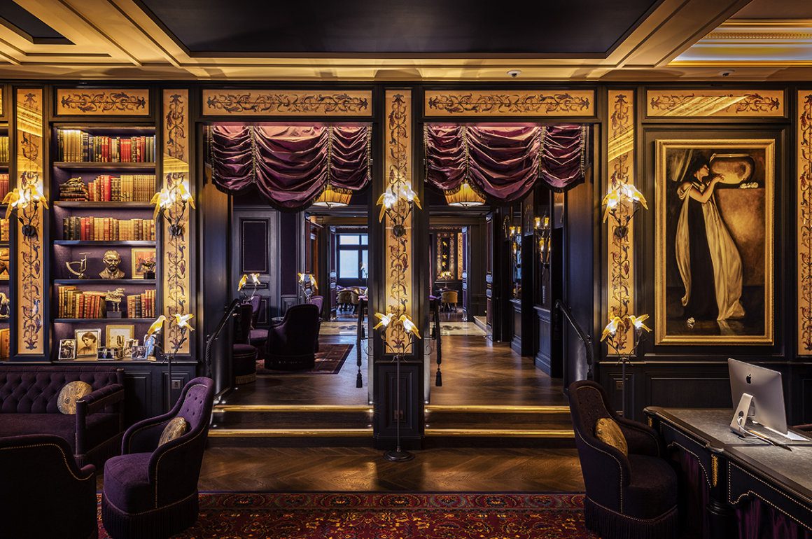 A grand hotel reception decorated in purple with gold and black detailing