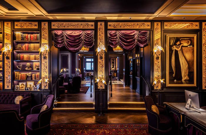 A grand hotel reception decorated in purple with gold and black detailing