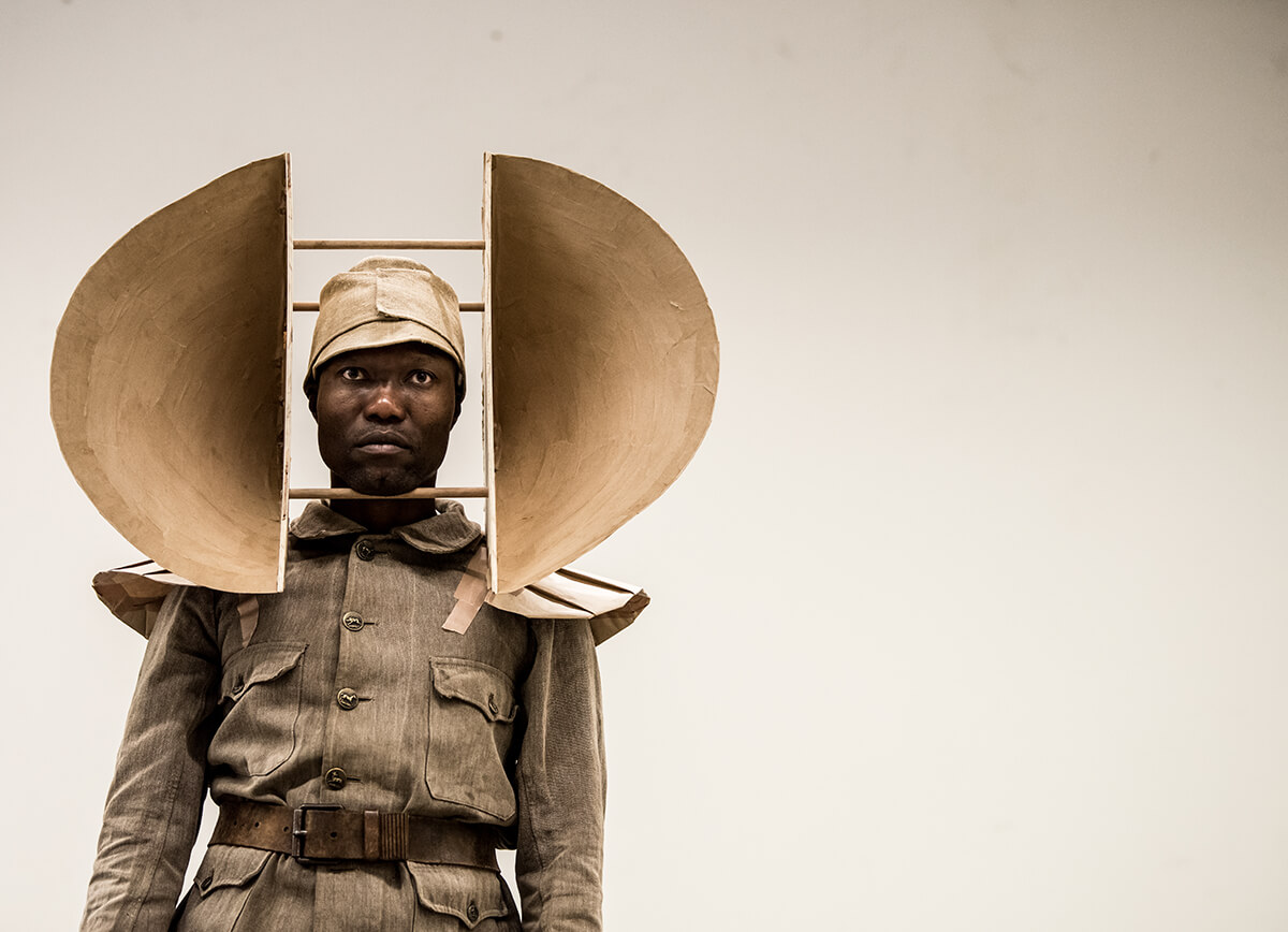 Portrait of man wearing uniform and head costume