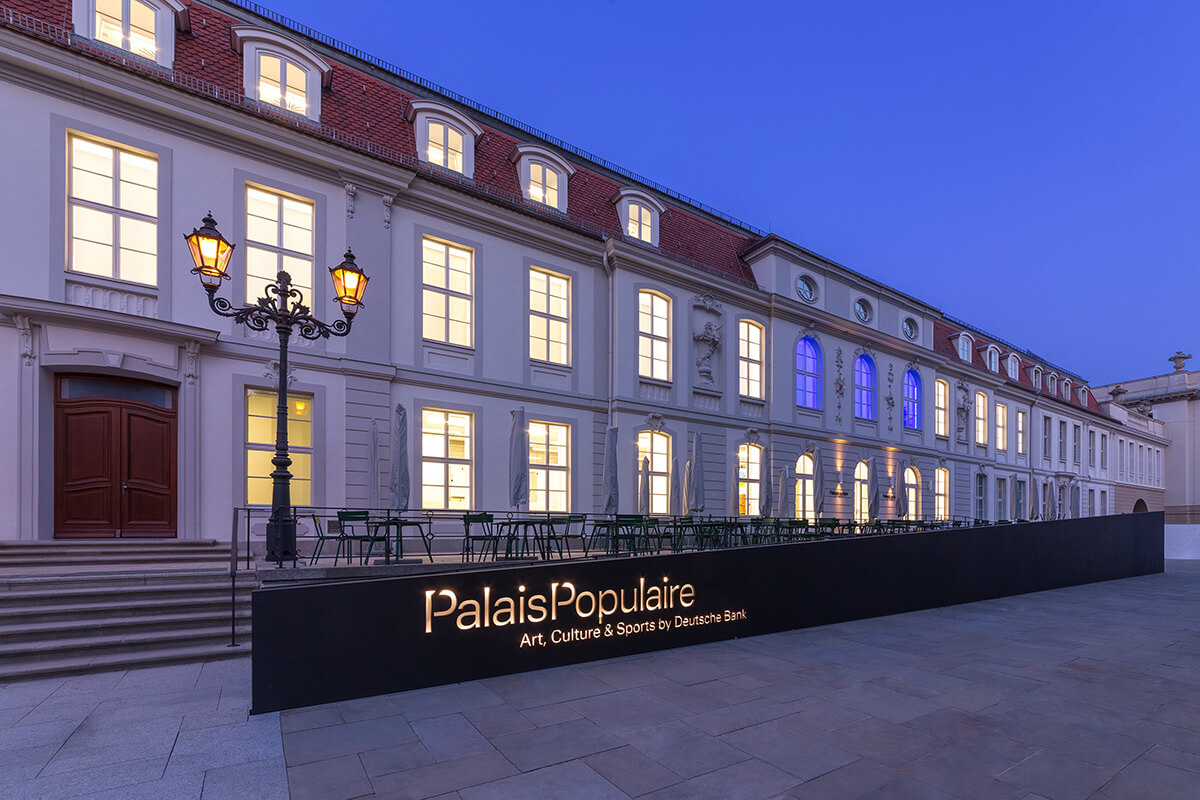 Facade of PalaisPopulaire at night with a dark indigo sky