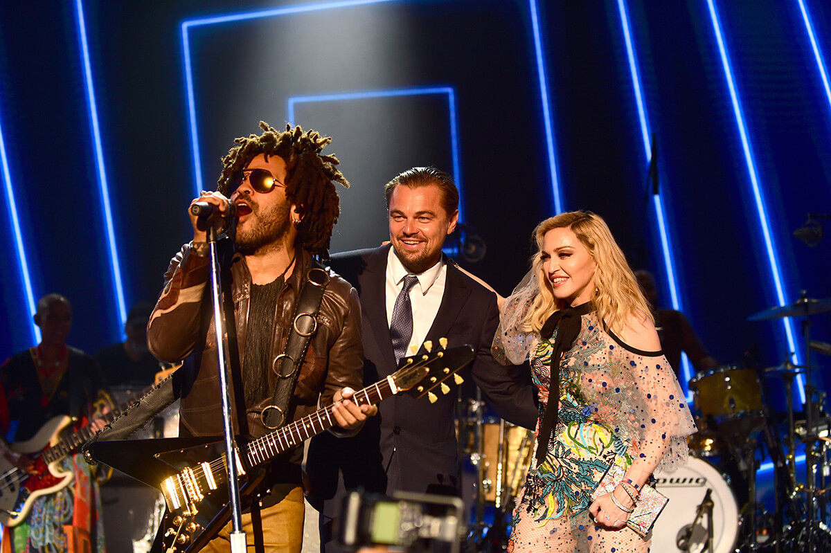 Singer Lenny Kravitz performs on stage with Leonardo DiCaprio and Madonna