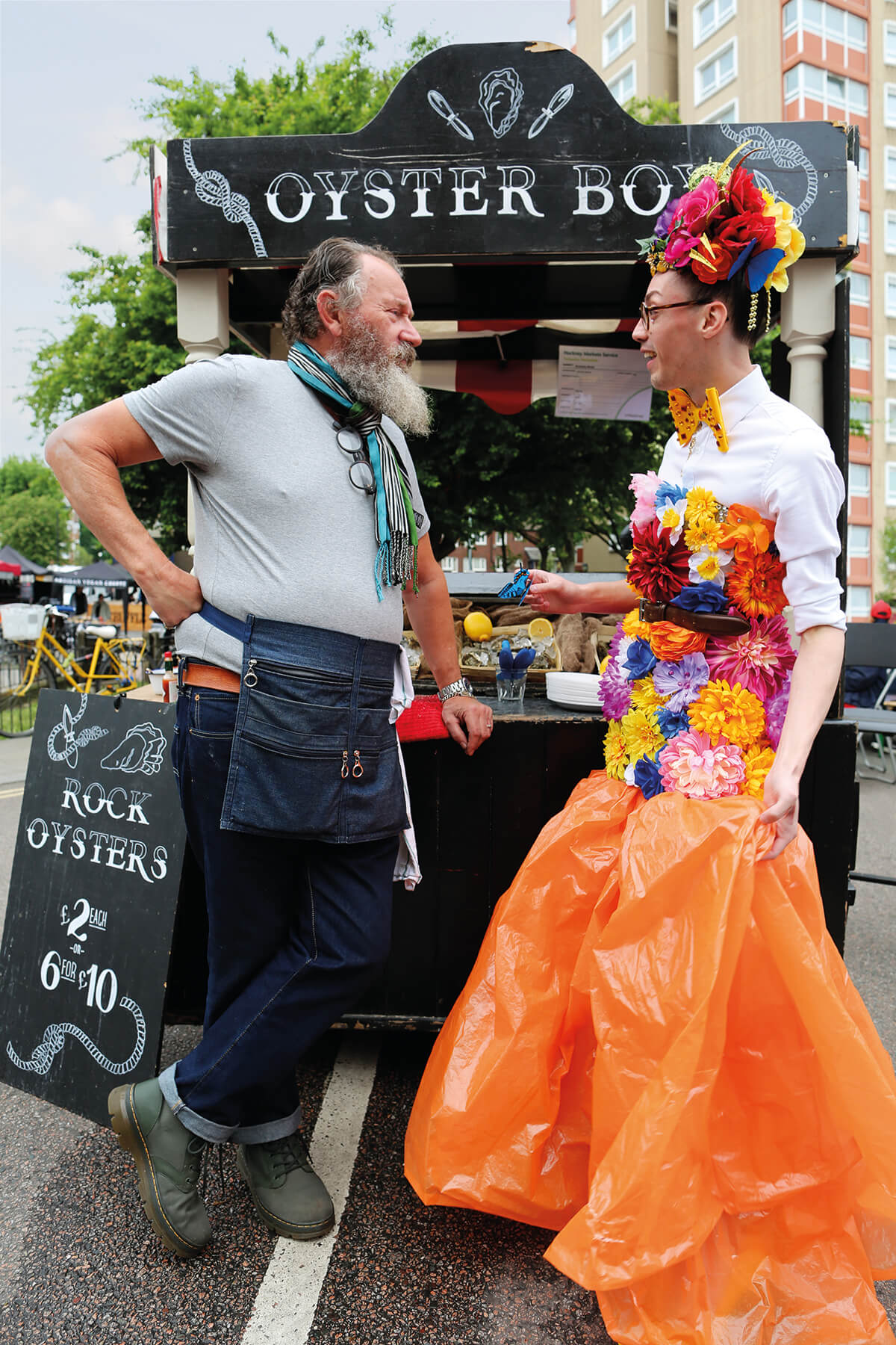Designer Florent Bidois pictured in conversation with a street vendoer