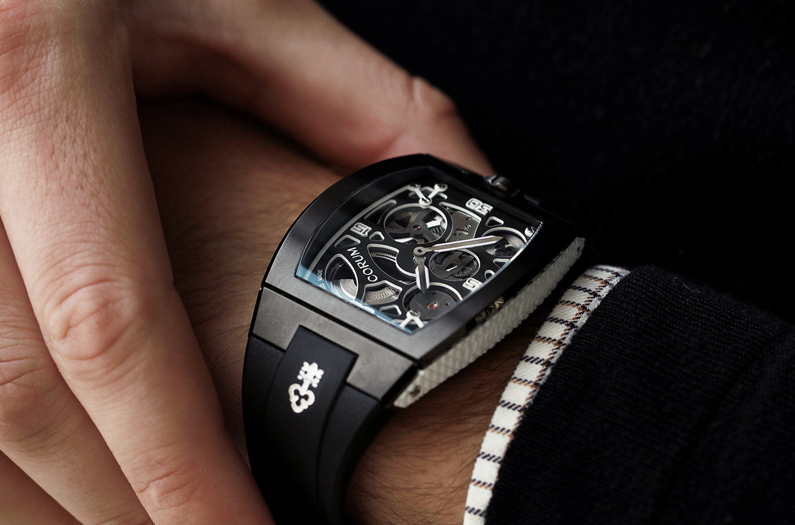 Luxury Corum watch shown on a man's wrist with rectangular watch-face