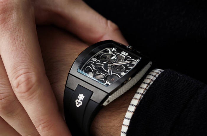 Luxury Corum watch shown on a man's wrist with rectangular watch-face