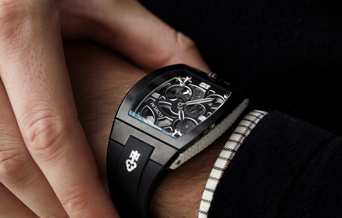 Luxury Corum watch shown on a man's wrist with rectangular watch-face 