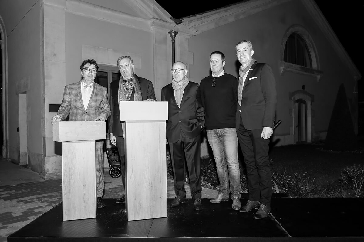 Panel of speakers standing on a stage at the inauguration of luxury hotel near bordeaux Chais Monnet