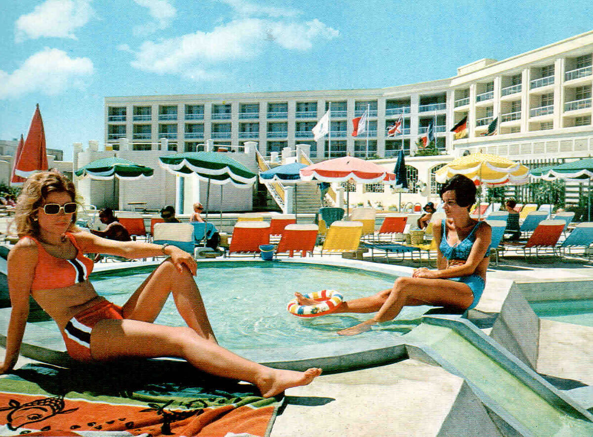 Vintage photograph of woman sunbathing by a hotel pool