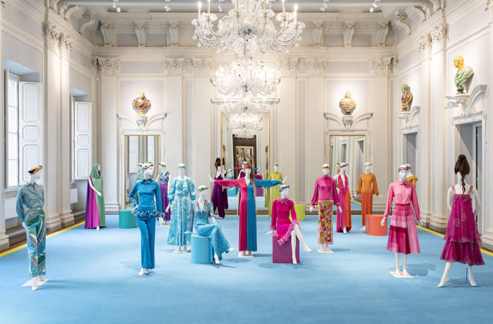 Fashion collection on display within a stately ballroom