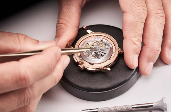 Luxury timepiece assembled by hand with tweezers