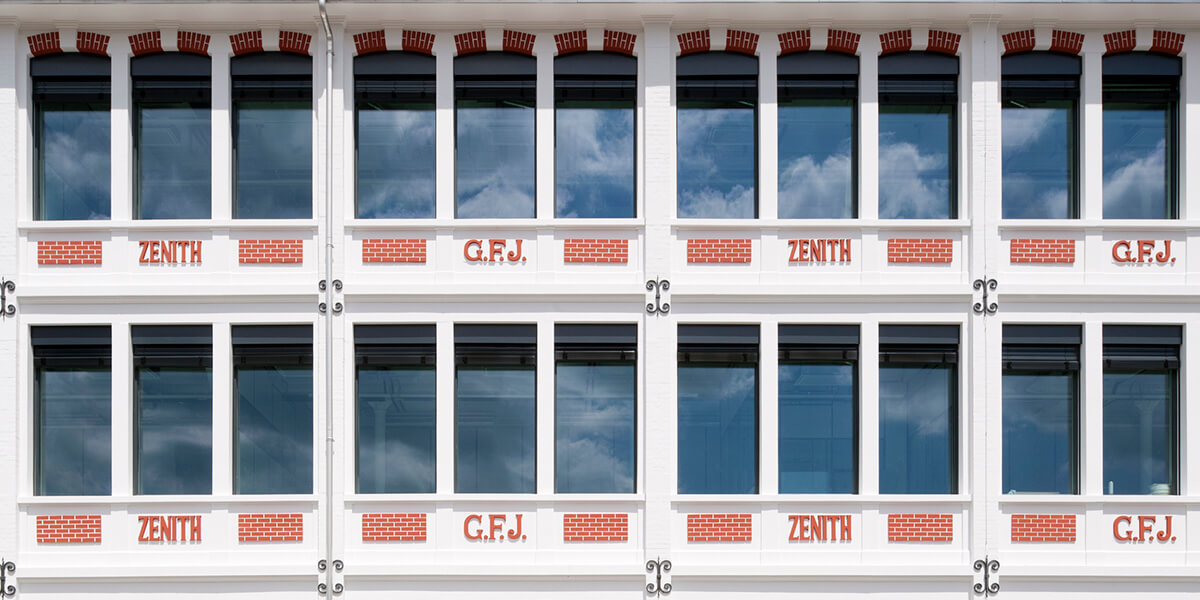 Zenith branded building with white facade and orange writing