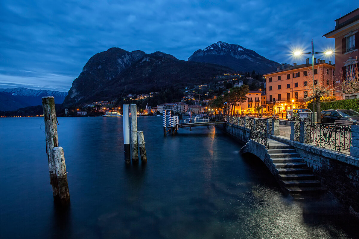 A traditional village jetty with mountains in the background