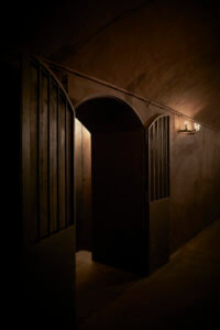 Wooden arched door to a wine cellar