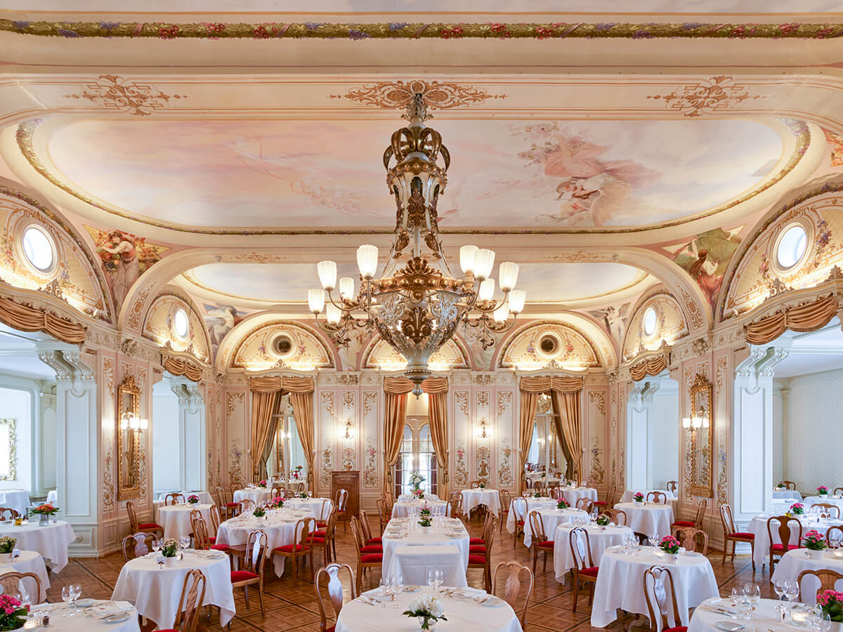 grand dining room with chandelier centre-piece and ballroom style tables