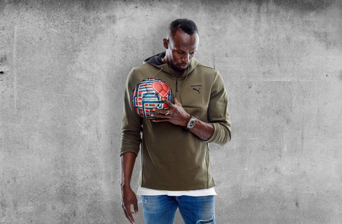Hublot brand ambassador Usain Bolt poses in front of textured wall