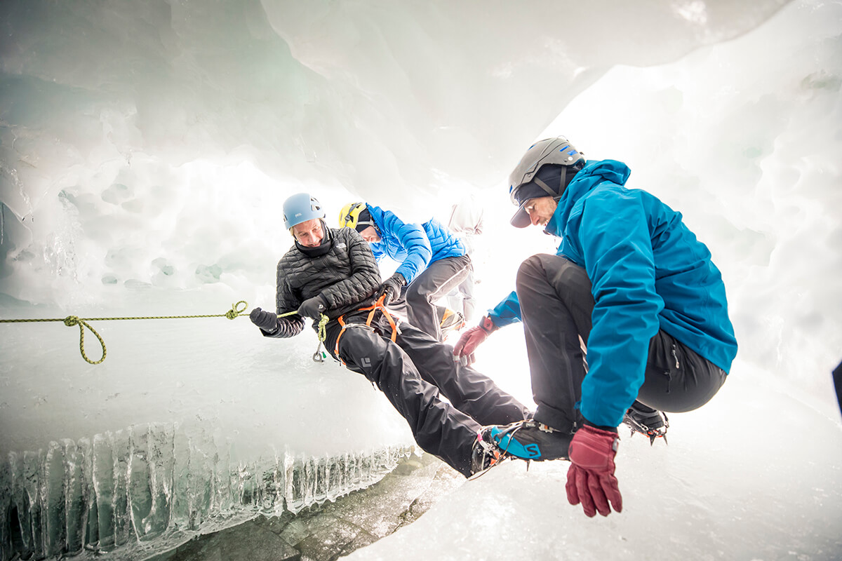 Explorers climb through an ice cave in the South Pole