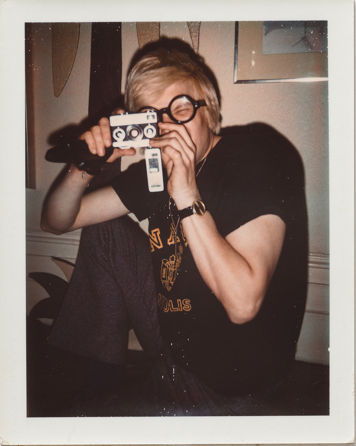 Polaroid of artist David Hockney taking a photo